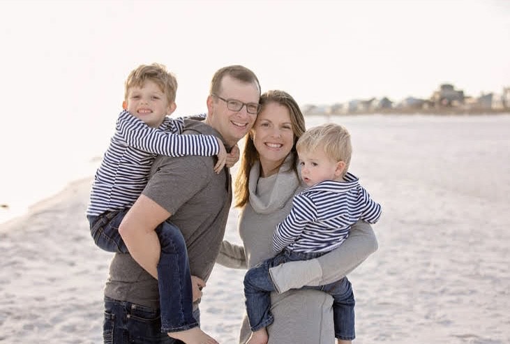 David and Allison Anderson with their two sons at the beach.