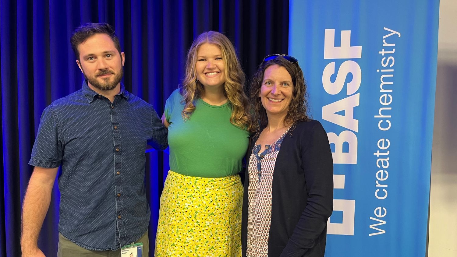 Peyton Gardner with the internal communications team in front of a BASF logo